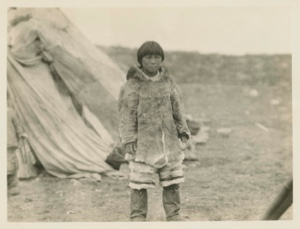 Image: Eskimo [Inuk] boy; The Eskimos of Baffin Land are clothed in caribou skins.